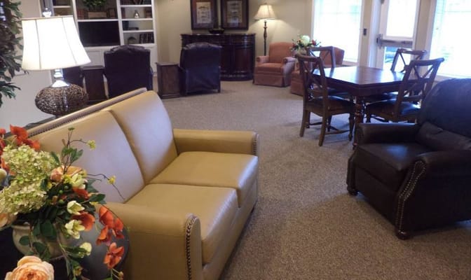 Cozy living room setup with seating and decorative flowers