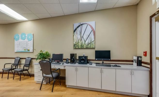 Reception desk with computers and seating in The Havens at Princeton.