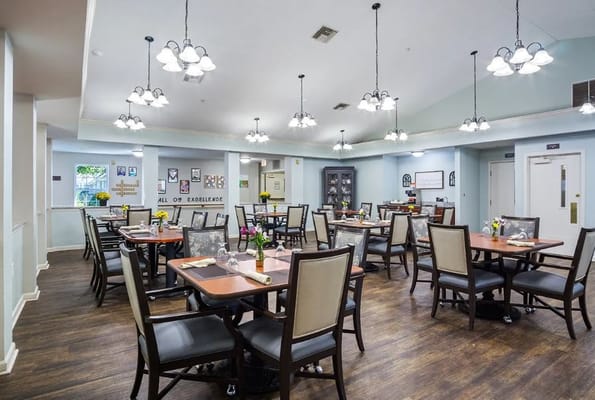 Bright and spacious dining room filled with tables and flowers