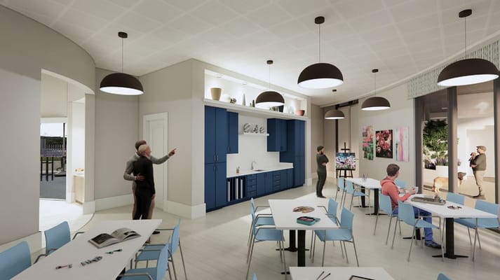 Light-filled common area with tables and residents socializing