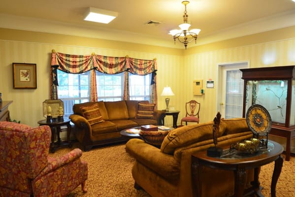 A cozy living room with comfortable seating and decorative elements.