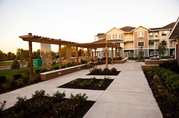 A view of the patio area with seating and flower beds at Meadowlark Estates.