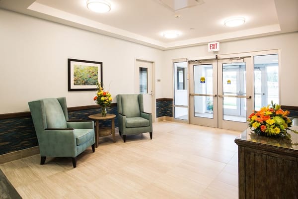 Interior view of a common area with seating and flowers