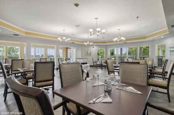 Well-furnished dining room with tables and chairs set for a meal