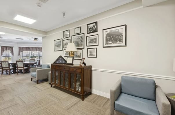 Comfortable living room with framed photographs and seating areas