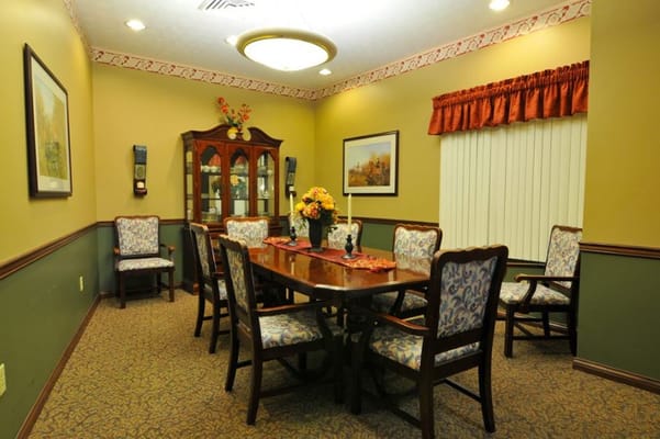 Cozy dining room with a wooden table and floral chairs