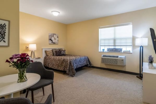 Cozy private resident room with bed and decor