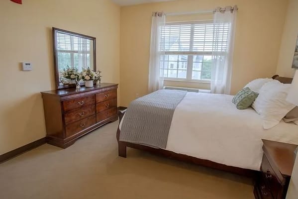 Private resident room with a bed and dresser