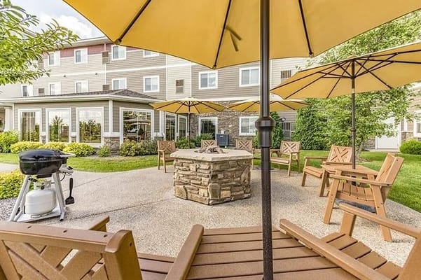 Outdoor seating area with umbrellas and grill