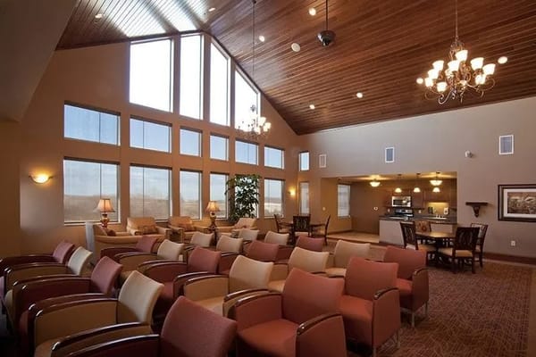 Common area lounge with seating and large windows