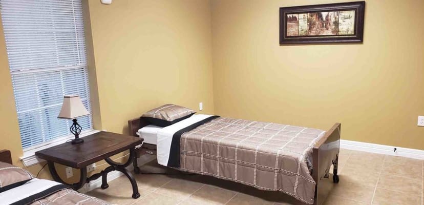 Cozy bedroom with two beds and a lamp.