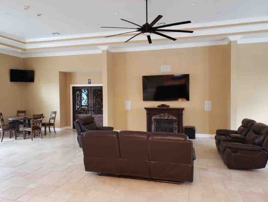 Spacious living room with leather couches and large TV