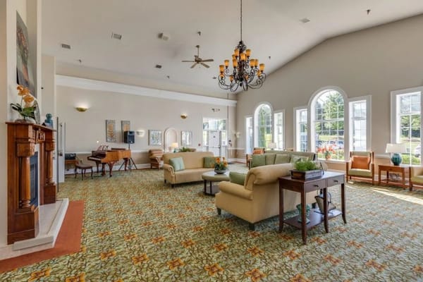 Spacious living room with comfortable seating and large windows