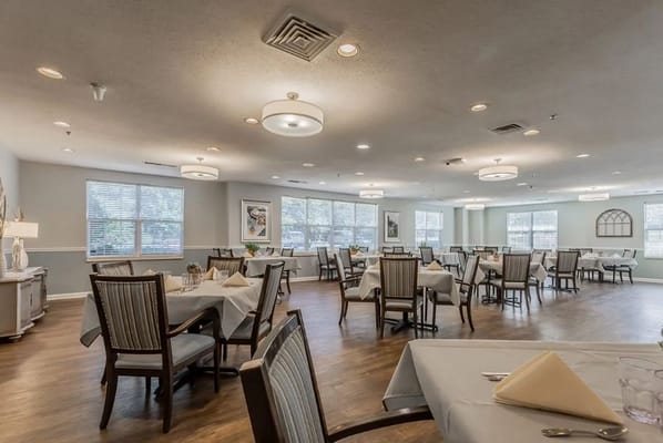 Bright dining room with tables set for meals