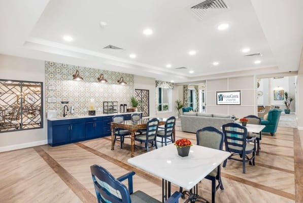 Bright common area with tables and chairs in StoneCreek of Copperfield Senior Living.