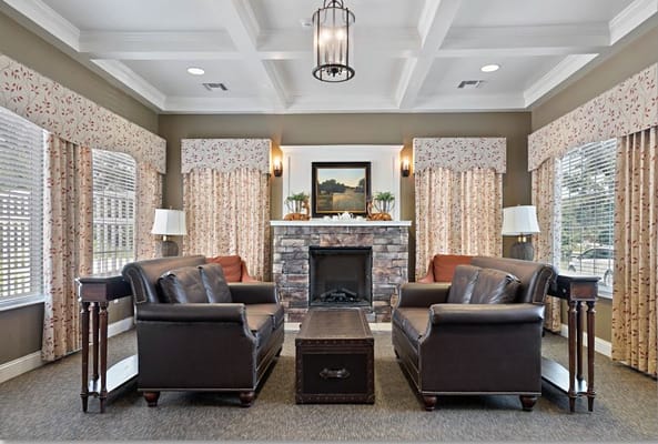 Comfortable seating area with a fireplace and decorative curtains