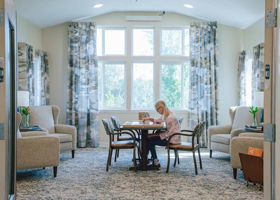 A resident engaged with a puzzle in a common area