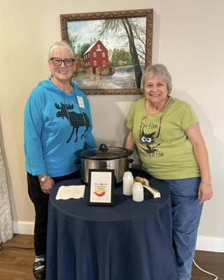Two residents enjoying an activity with food