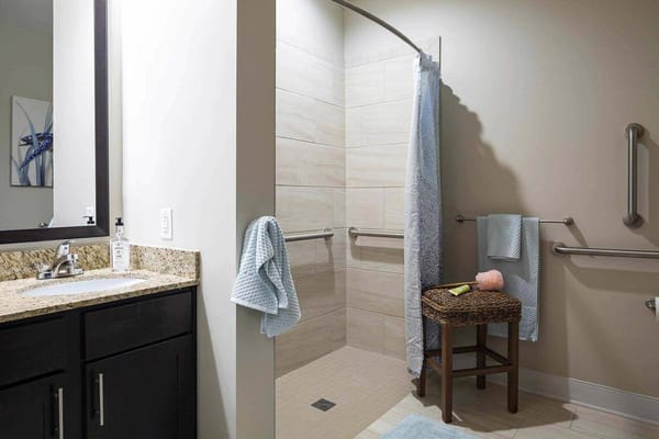 Well-lit bathroom with modern amenities and safety features