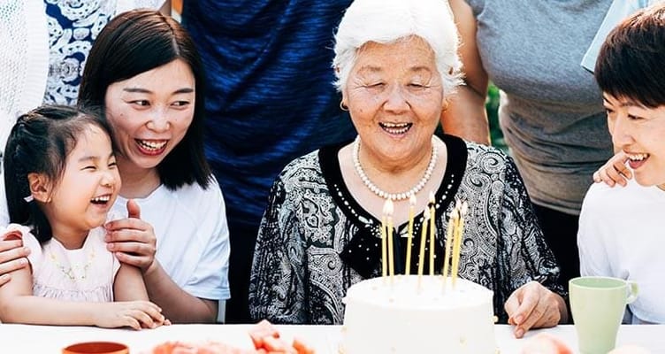 A joyful birthday celebration with a resident and family members