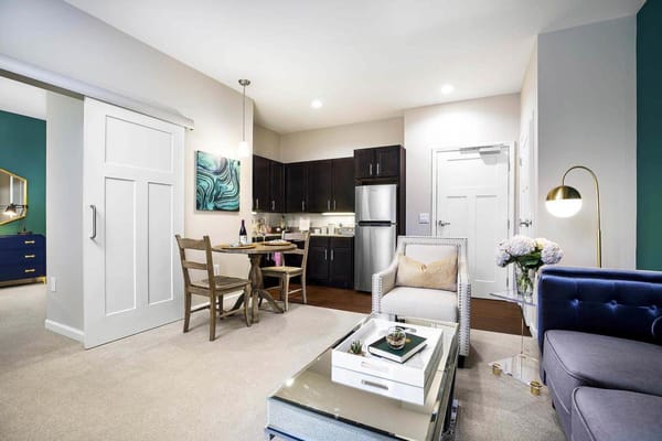 A stylish resident room with a kitchen and living area