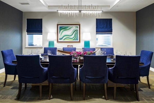 Elegant dining room with blue chairs and floral centerpiece