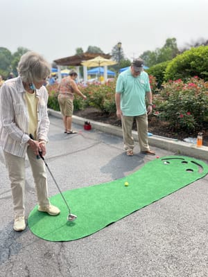 Residents enjoying a fun outdoor putting activity