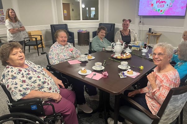 Residents enjoying tea time together at a communal table