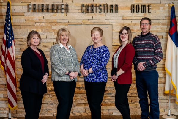 Staff members posing in a common area of the facility