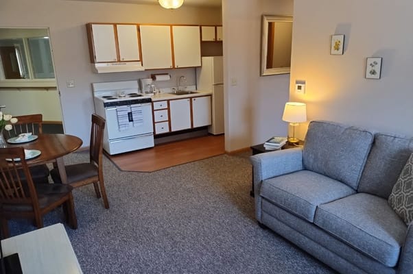 Cozy resident room with kitchenette and dining area