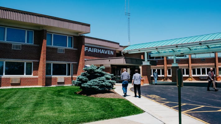 Facility exterior with people approaching entrance