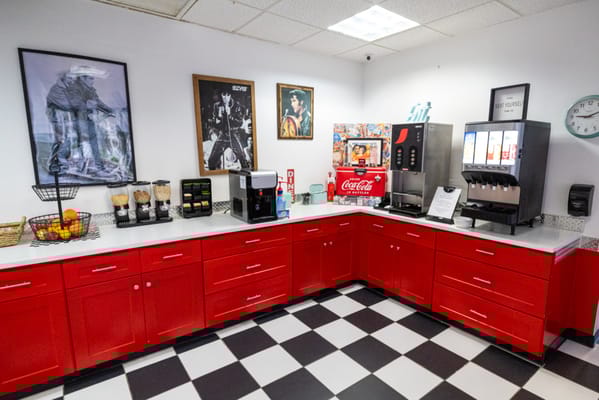 Bright interior of a snack area with red cabinets and beverages