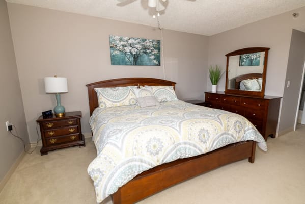 Cozy bedroom with a bed and dresser in a senior living space
