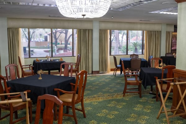 Dining area with tables and chairs set up for meals
