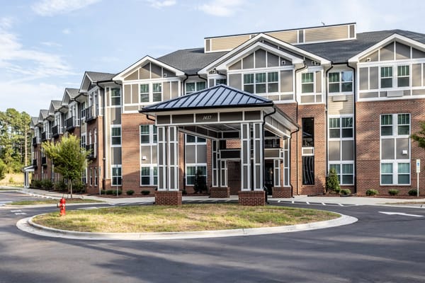 Exterior view of a senior living facility with covered entrance