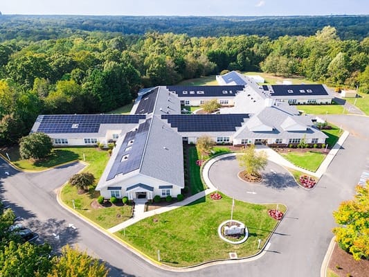 Aerial view of the senior living facility surrounded by trees