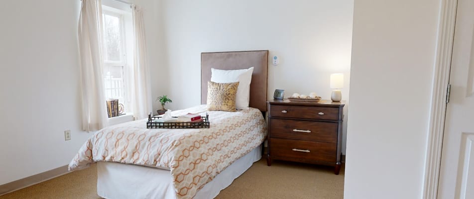 Cozy private resident room with a bed and decor