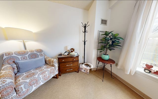 Cozy resident room with a couch and plant