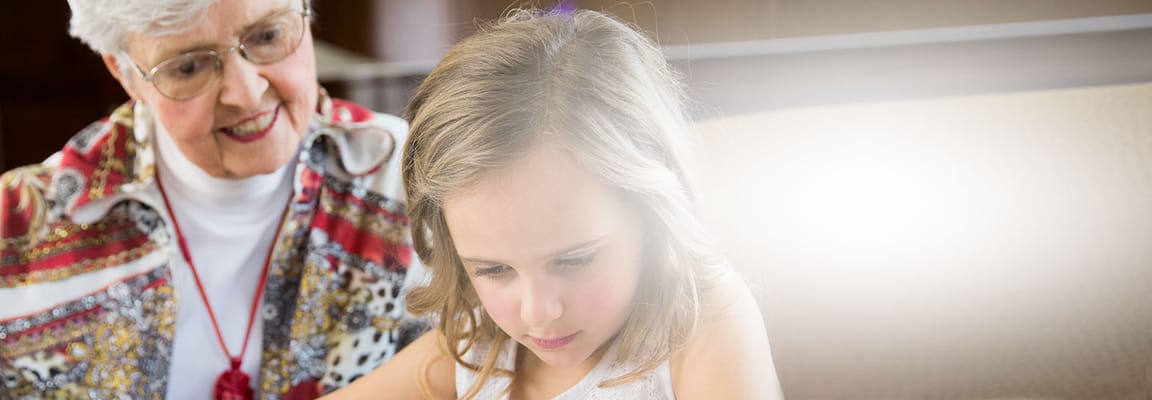 Senior woman interacting with a young girl in a facility setting