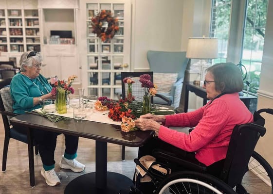 Residents arranging flowers in a common room