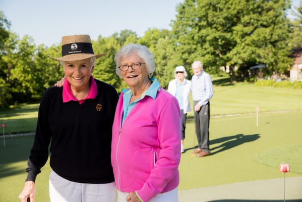 Two residents enjoying outdoor golfing activities