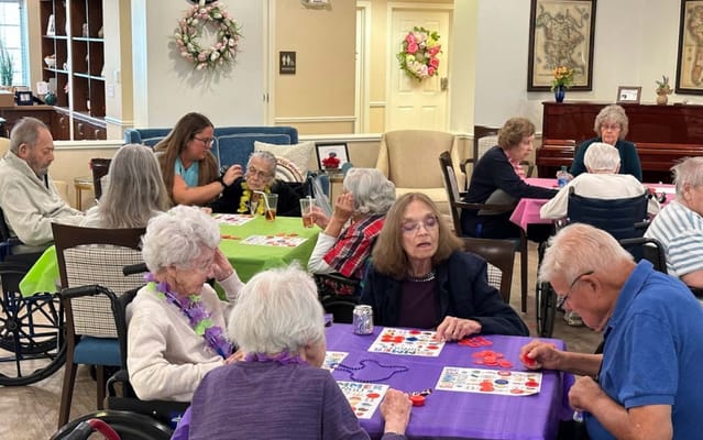 Residents engaging in a bingo activity in a common area