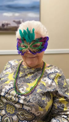 Resident wearing a colorful mask during a celebration