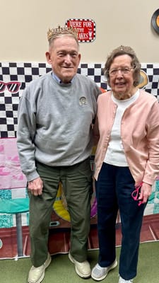 Two residents posing together at a celebration event