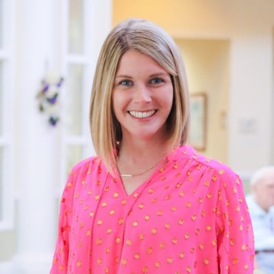 Staff member smiling in a bright facility interior