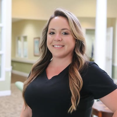 Staff member smiling in a facility hallway