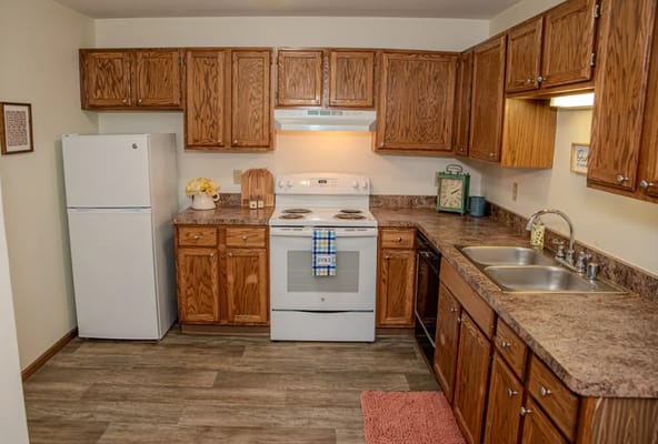 Cozy kitchen area with wooden cabinets and appliances