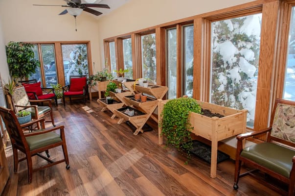 Bright interior space with plants and seating areas