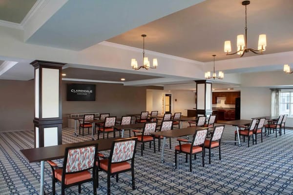 Interior view of a spacious activity room with tables and chairs
