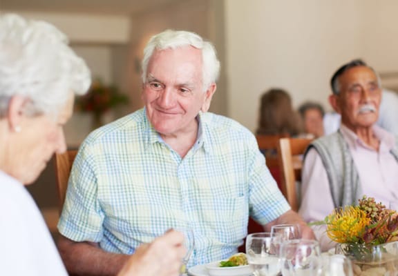 Residents enjoying a meal in the dining room